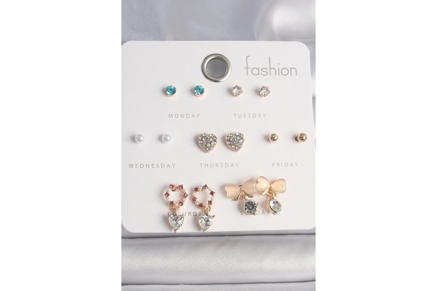 Shoecide Pirinç Gold Renk Zirkon Taşlı Kalp Beyaz Mineli Fiyonk Figür 7 Çift Kadın Küpe Seti