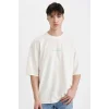 Defacto C2732 Ekru Loose Fit Bisiklet Yaka Sırt Baskılı Kısa Kollu Tişört