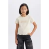 Defacto B6689A8ER42 Ekru Slim Fit Dar Kesim Bisiklet Yaka Baskılı Fitilli Kaşkorse Kısa Kollu Tişört Kız Çocuk