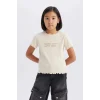 Defacto B6689A8ER42 Ekru Slim Fit Dar Kesim Bisiklet Yaka Baskılı Fitilli Kaşkorse Kısa Kollu Tişört Kız Çocuk