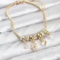BUĞZ Pirinç Gold Renk Kutup Yıldızı ve Kalp Charmlı Kadın Bileklik