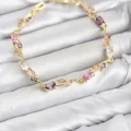 BUĞZ Pirinç Gold Renk Pembe ve Mor Zirkon Taşlı Çiçek Model Kadın Bileklik