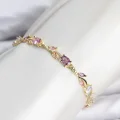 BUĞZ Pirinç Gold Renk Pembe ve Mor Zirkon Taşlı Çiçek Model Kadın Bileklik