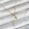 BUĞZ Pirinç Gold Renk Zirkon Taşlı Minimal Sallantılı Kutup Yıldızı Model Kadın Kolye