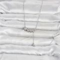 BUĞZ Pirinç Gümüş Renk Minimal Sallantılı Yıldız Model Kadın Kolye - BUĞZ