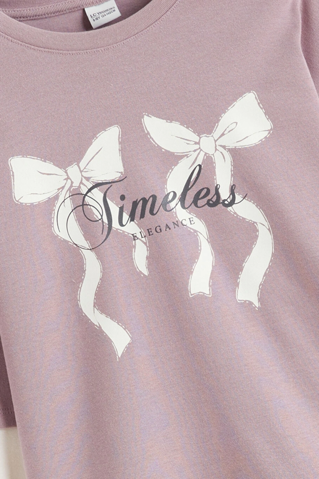 LCW Kids Lila Bisiklet Yaka Fiyonk Baskılı Kız Çocuk Tişört