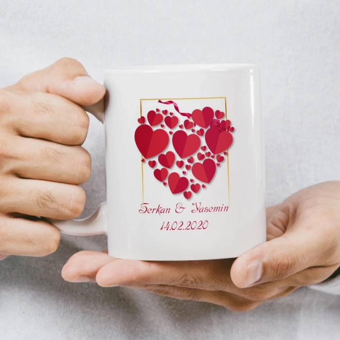 Kalp ve balonlarla çevrili, birbirini öpen karikatür çiftin bulunduğu kupa baskısı.