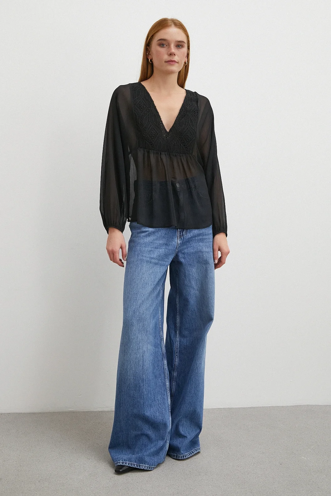 V-Ausschnitt, mit Spitze besetzte, transparente Bluse in Schwarz