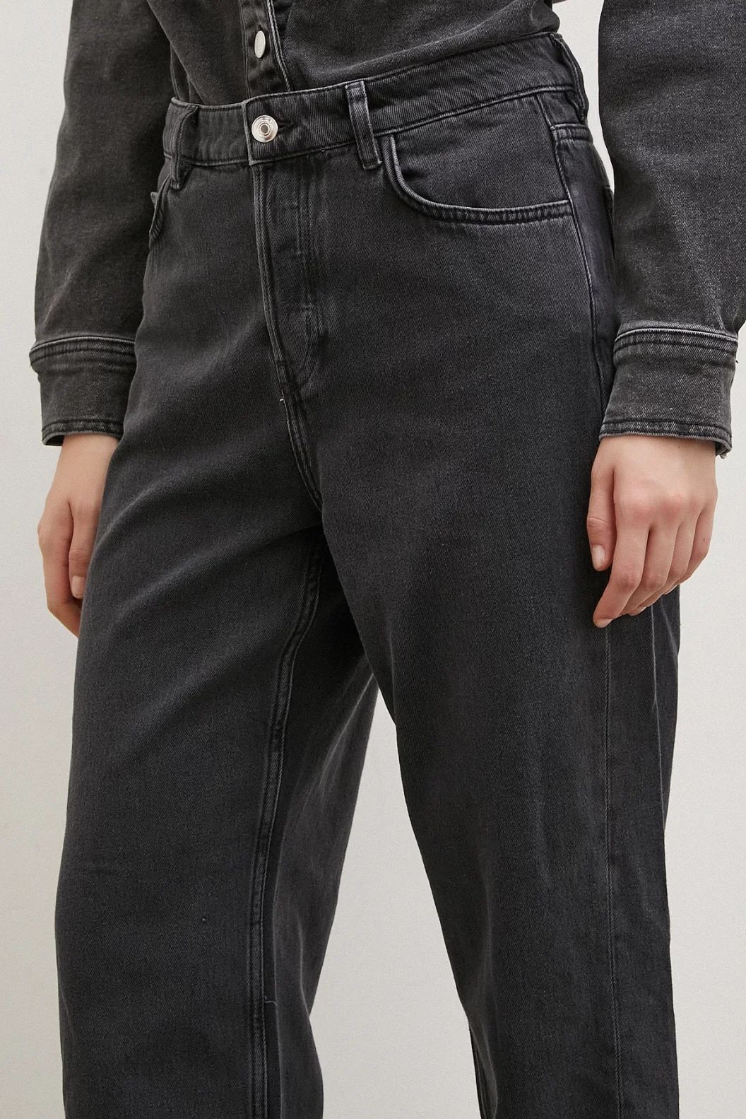 سروال جينز أسود مع خصر عالي وأساور منخفضة