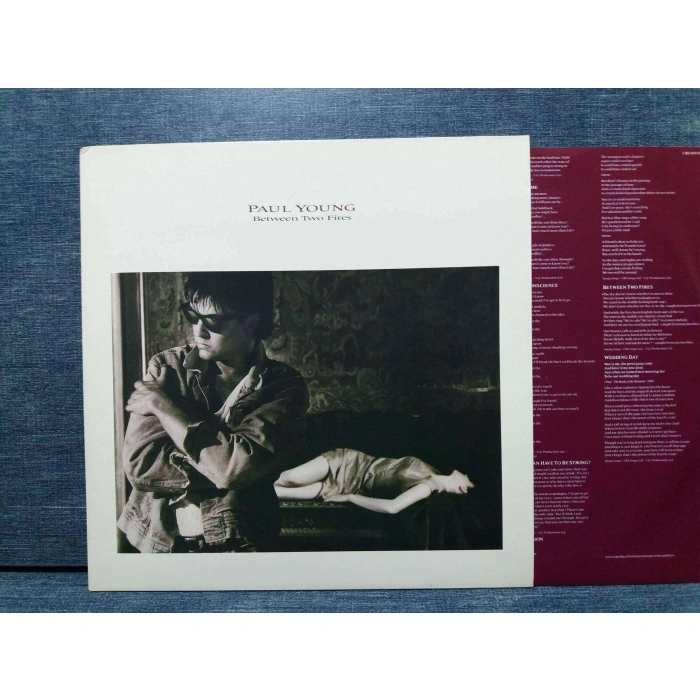 PAUL YOUNG BETWEEN TWO FIRES