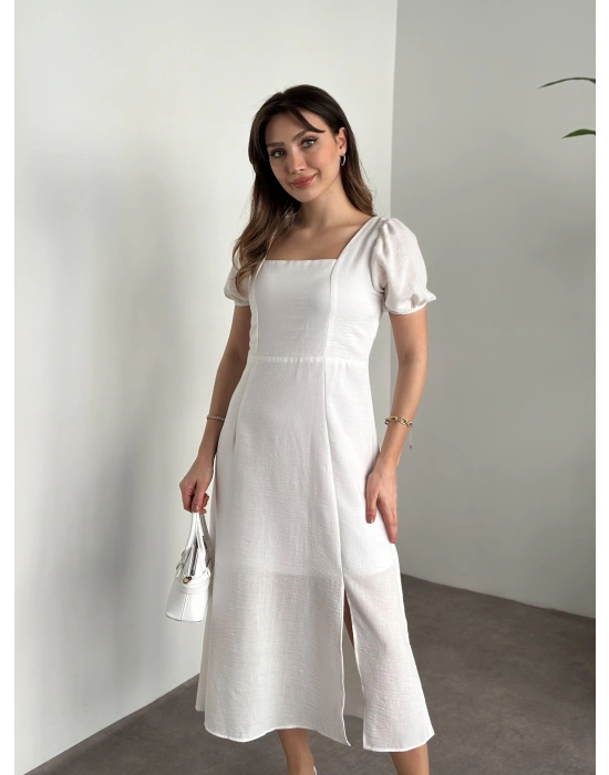 Sırt dekolteli ve yırtmaçlı keten elbise beyaz