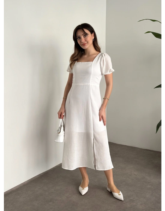 Sırt dekolteli ve yırtmaçlı keten elbise beyaz