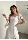 Sırt dekolteli ve yırtmaçlı keten elbise beyaz
