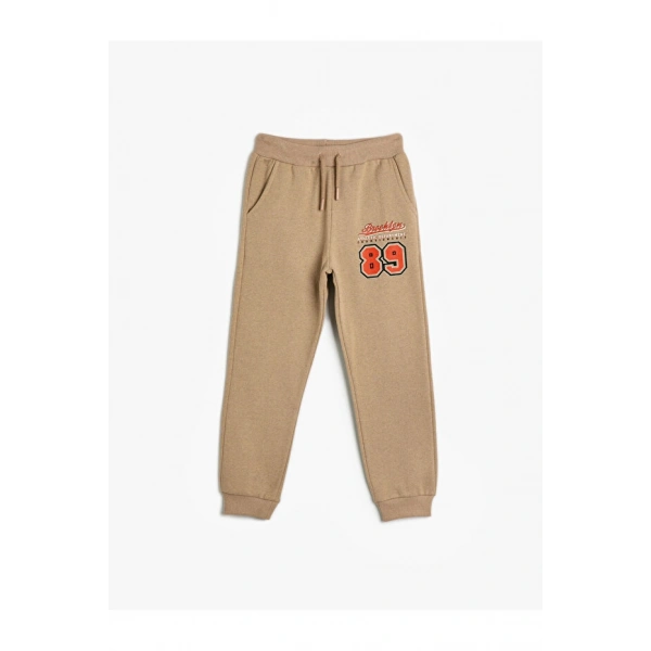 Koton Basic Jogger Eşofman Altı Spor Temalı Baskı Detaylı Beli Bağlamalı Şardonlu