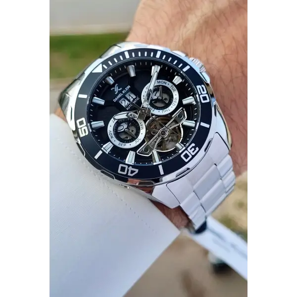 Daniel Klein DKISTE1261 Kadranı Siyah Kordonu Gümüş Renk Otomatik Takvimli Hediye Paketli Erkek Kol Saati