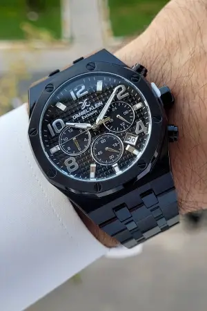 Daniel Klein DKISTE1389 Rakamları Gümüş Kordonu Siyah Renk Hediye Paketli Göstergeleri Aktif Erkek Kol Saati